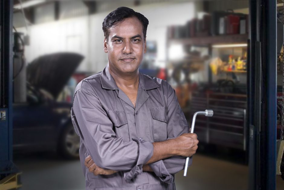 Friendly auto mechanic ready to assist with tire services