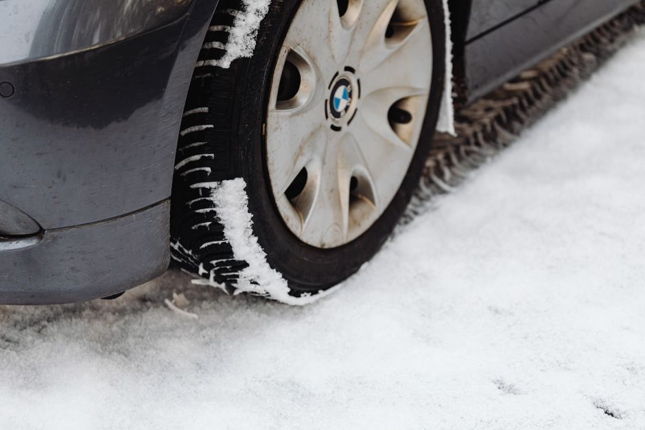 Mechanic performing a wheel alignment and tire rotation